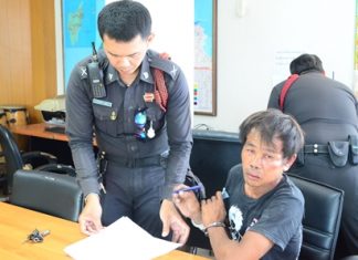 Sumrit Kalasin signs the police report after allegedly trying to rape his neighbor.